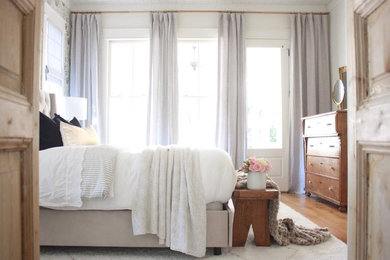 Example of a farmhouse master bedroom design in Atlanta with gray walls