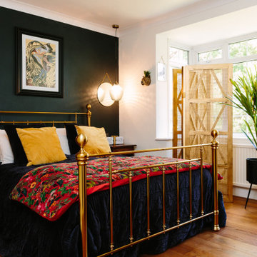A luxurious master bedroom with bold feature wall