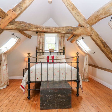 A quirky, pretty, oak-beamed guest bedroom