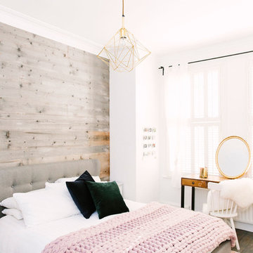 A rustic bedroom with a touch of blush and brass