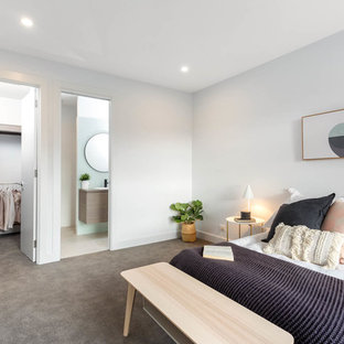 This is an example of a mid-sized contemporary guest bedroom in Adelaide with white walls, carpet and grey floor.