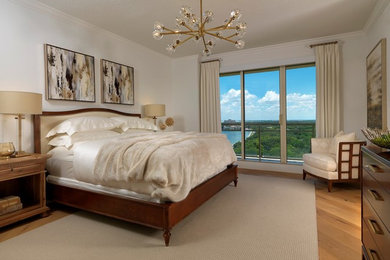 Mid-sized trendy master light wood floor and beige floor bedroom photo in Tampa with white walls and no fireplace