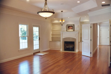 Inspiration for a mid-sized master medium tone wood floor bedroom remodel in Baltimore with beige walls