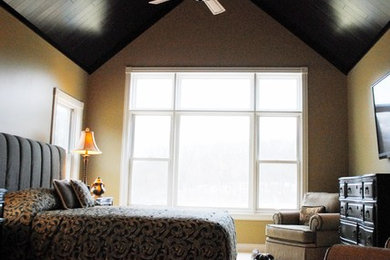グランドラピッズにある広いトランジショナルスタイルのおしゃれな主寝室 (茶色い壁、カーペット敷き) のインテリア