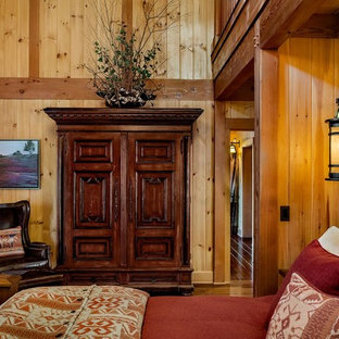 Large mountain style master dark wood floor bedroom photo in Burlington with brown walls and no fireplace