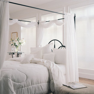 Large cottage chic master light wood floor bedroom photo in Other with white walls and no fireplace