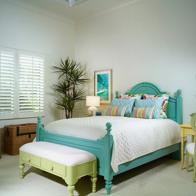 Inspiration for a tropical carpeted bedroom remodel in Miami with white walls