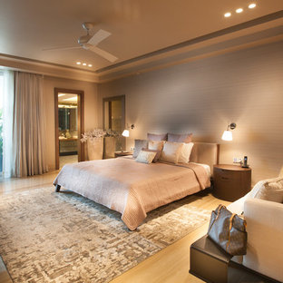 Large contemporary bedroom in Delhi with beige walls.