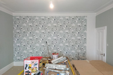 Imagen de dormitorio tradicional renovado con paredes grises, marco de chimenea de metal y papel pintado