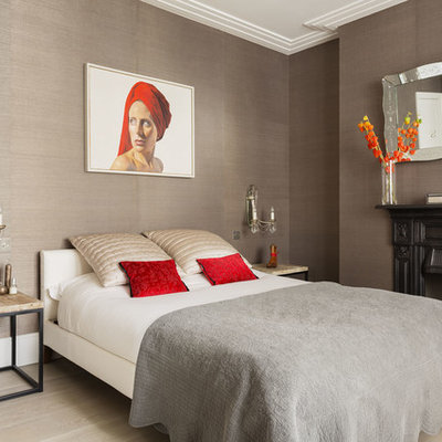 Inspiration for a transitional light wood floor bedroom remodel in London with a standard fireplace and brown walls