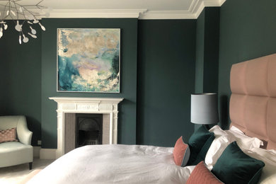 Inspiration for a medium sized modern master bedroom in London with blue walls, carpet, a standard fireplace, a wooden fireplace surround and beige floors.