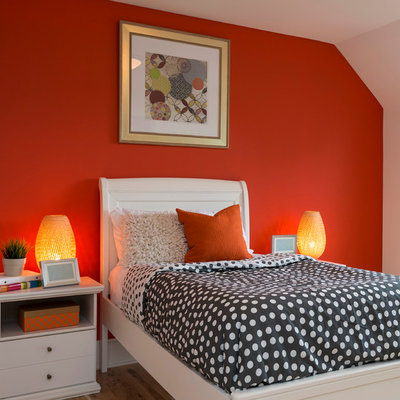 Inspiration for a timeless medium tone wood floor bedroom remodel in Minneapolis with orange walls and no fireplace