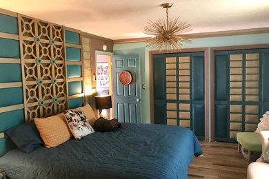 Inspiration for a large transitional master light wood floor and blue floor bedroom remodel in Albuquerque with blue walls and no fireplace