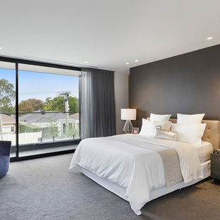 Photo of a mid-sized contemporary master bedroom in Melbourne with carpet, grey walls and grey floor.