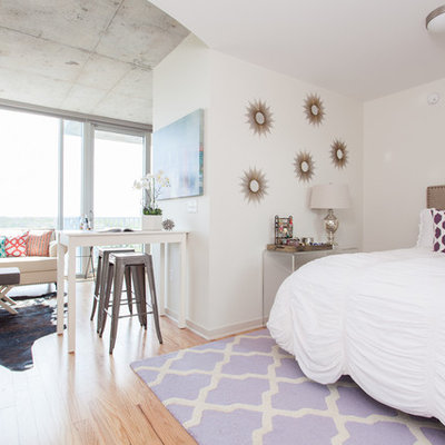 Small danish light wood floor bedroom photo in Austin with white walls