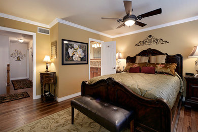 Large transitional master medium tone wood floor and brown floor bedroom photo in Orange County with brown walls and no fireplace