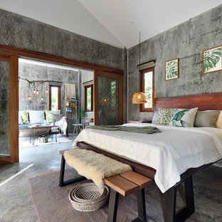 Modelo de dormitorio tropical con paredes grises, suelo de cemento y suelo gris