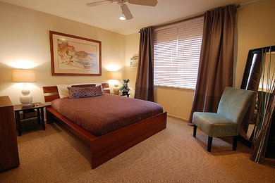 This is an example of a small contemporary guest bedroom in Los Angeles with beige walls, carpet and no fireplace.