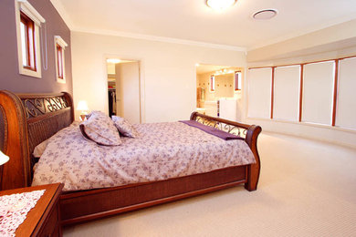 Ejemplo de dormitorio principal actual grande con paredes beige, moqueta y suelo negro