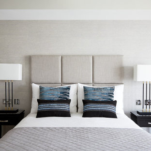 Design ideas for a large contemporary master bedroom in London with grey walls, medium hardwood flooring, a vaulted ceiling and wallpapered walls.
