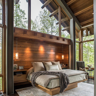 Imagen de dormitorio principal, actual, grande, con suelo de madera oscura, paredes marrones y suelo marrón