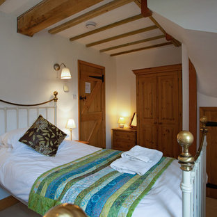 Imagen de habitación de invitados rural, de tamaño medio, con paredes beige, suelo de baldosas de cerámica y suelo beige