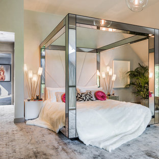 This is an example of a contemporary master bedroom in London with carpet and grey floors.