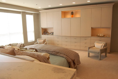 Modelo de dormitorio contemporáneo con paredes beige, moqueta y suelo beige