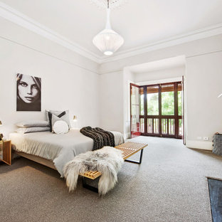 This is an example of a scandinavian master bedroom in Adelaide with grey walls, carpet, a standard fireplace and beige floor.