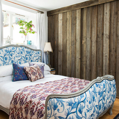Example of a classic light wood floor bedroom design in London with white walls