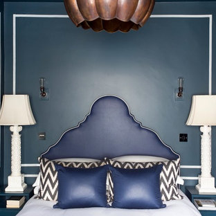 Bedroom - eclectic bedroom idea in London with blue walls
