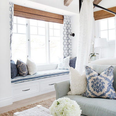 Bedroom - mid-sized coastal master light wood floor bedroom idea in Orange County with white walls