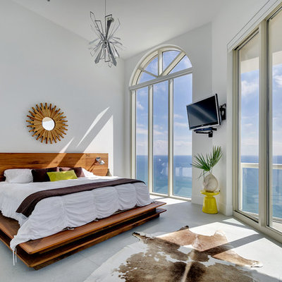 Inspiration for a contemporary bedroom remodel in Miami with white walls and no fireplace