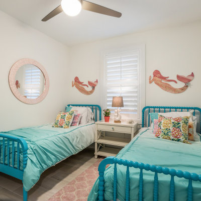 Example of a beach style bedroom design in Tampa with white walls
