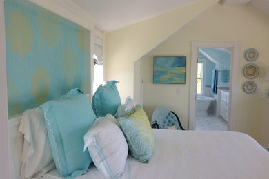 Large beach style master bedroom photo in Boston with yellow walls and no fireplace
