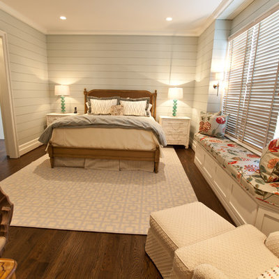 Example of a beach style dark wood floor bedroom design in Raleigh with gray walls
