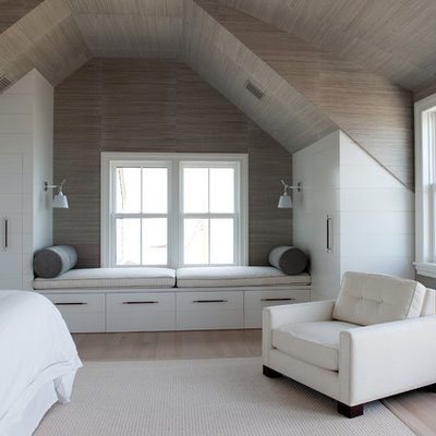 Example of a beach style light wood floor bedroom design in Boston with white walls