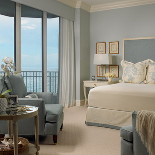 Example of a beach style carpeted bedroom design in Miami with blue walls