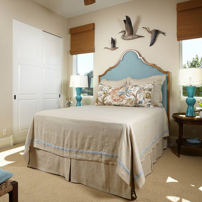Example of a beach style carpeted bedroom design in Miami with beige walls