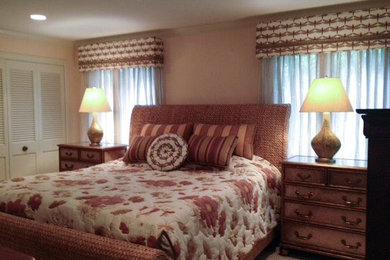 Mid-sized island style master carpeted bedroom photo in New York with pink walls