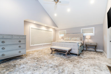 Large trendy master carpeted and multicolored floor bedroom photo in Cleveland with gray walls and no fireplace