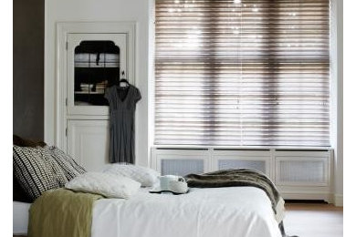 Inspiration for a master light wood floor bedroom remodel in Wilmington with white walls and no fireplace