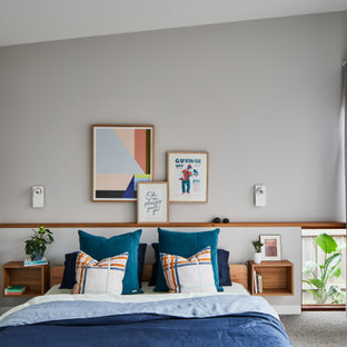Contemporary bedroom in Melbourne with grey walls, carpet, grey floor and vaulted.
