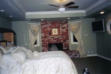 Inspiration for a large timeless master carpeted bedroom remodel in Los Angeles with beige walls, a standard fireplace and a brick fireplace