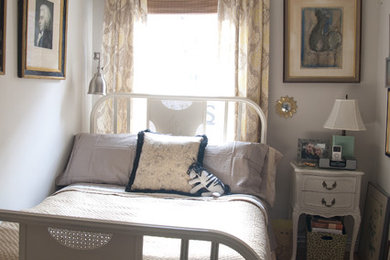 Photo of a small shabby-chic style grey and cream bedroom in New York with grey walls, medium hardwood flooring and feature lighting.