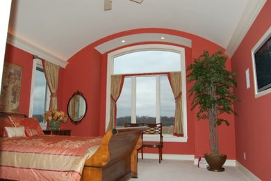 Example of a mid-sized carpeted bedroom design in Minneapolis with red walls and no fireplace
