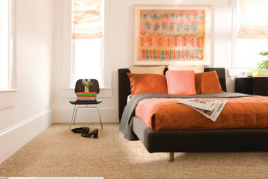 Example of a mid-sized trendy master carpeted and brown floor bedroom design in New York with white walls and no fireplace