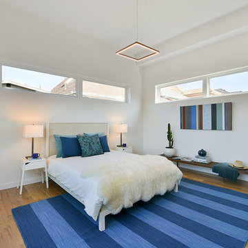 Bedroom full of natural wood, white walls and abundant light