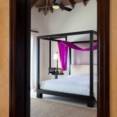 Example of an island style bedroom design in New York with white walls