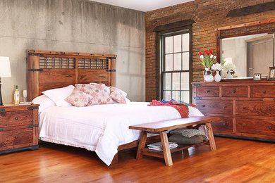Bedroom - large cottage guest medium tone wood floor and brown floor bedroom idea in Other with gray walls